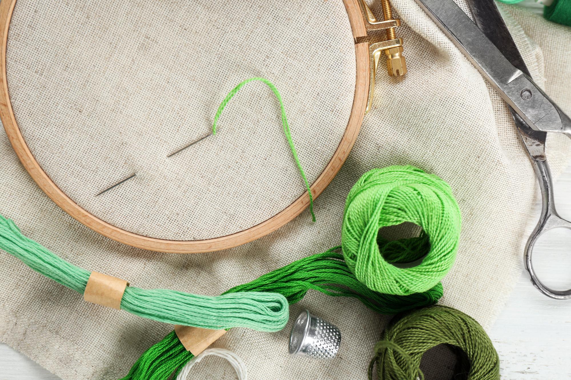 Studio workspace with embroidery hoop and tools